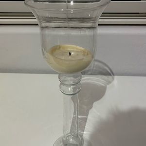 Two large glass candle holders.